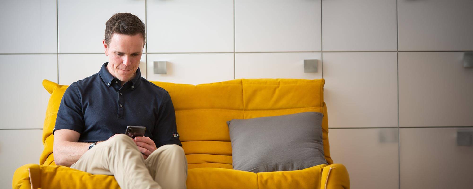 Golfer using phone in club house